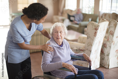 Nurse talking to patient in wheelchair