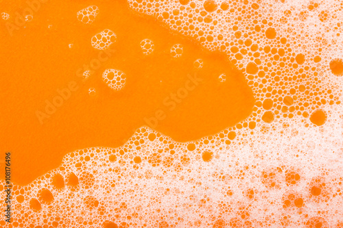 foam on orange background macro