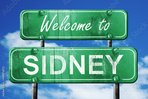 sidney vintage green road sign with blue sky background photo