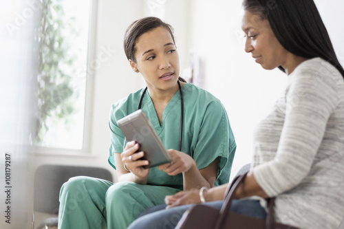 Nurse and patient using digital tablet photo