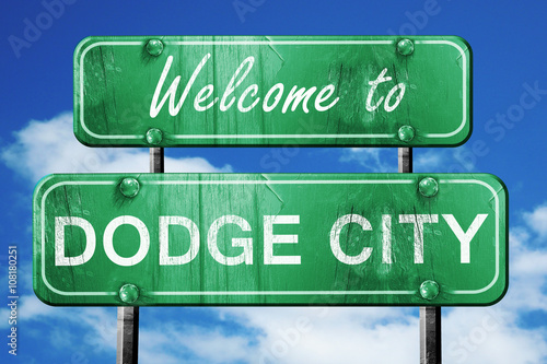 dodge city vintage green road sign with blue sky background