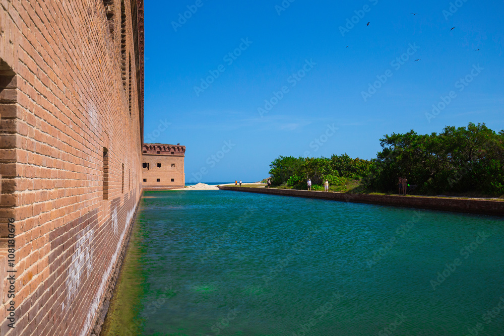 Standing on the moat which surrounds Fort Jefferson Civil War Fort and a prison for confederate soldiers