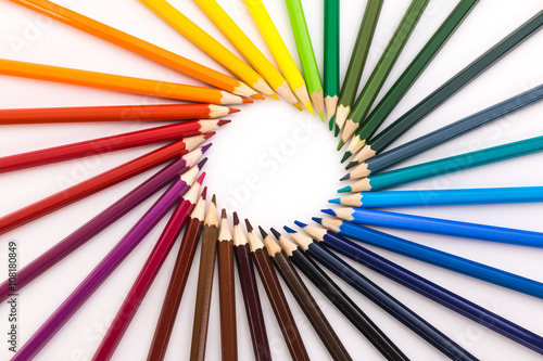 circle of colored pencils on white background