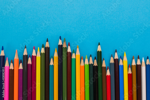 colored pencils on a blue background