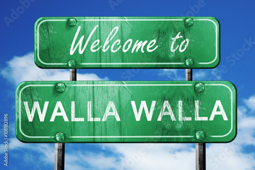 walla walla vintage green road sign with blue sky background photo