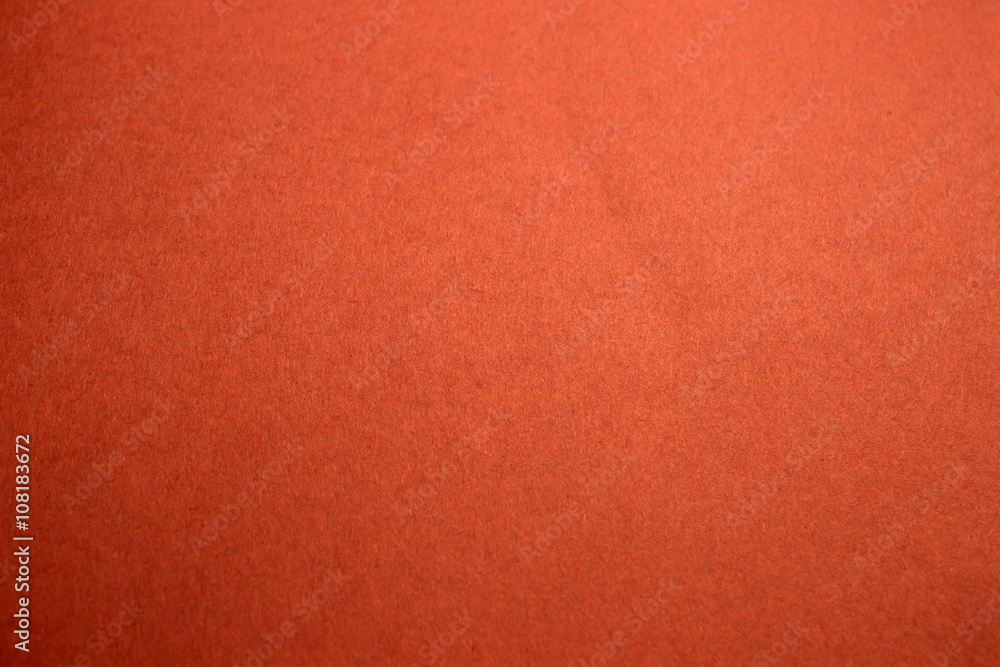 This is a photograph of a Bright Neon Orange construction paper background  Stock Photo