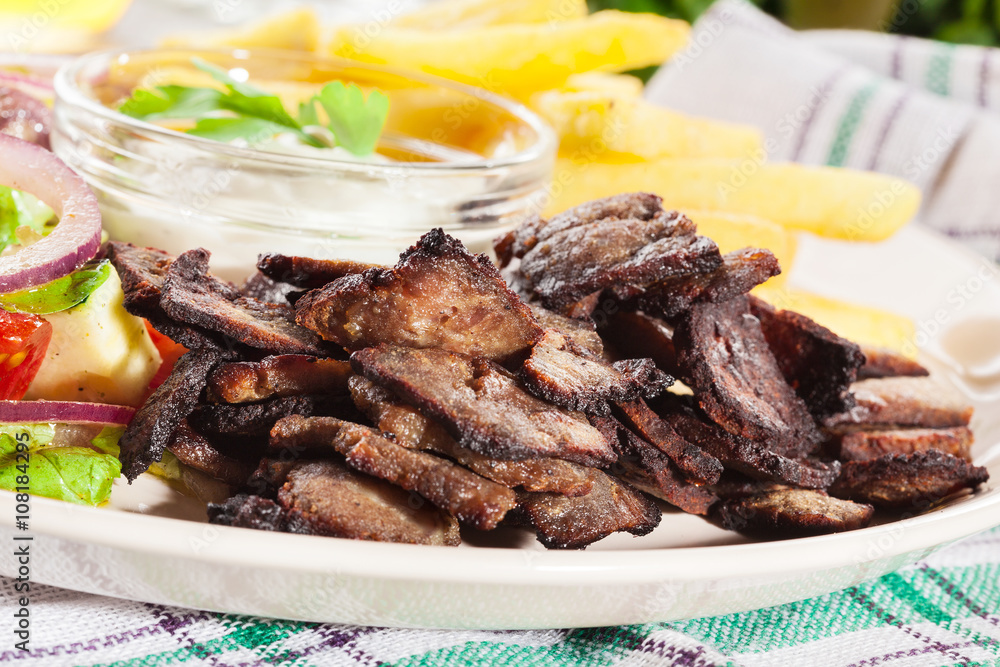 Grilled meat with French fries and fresh vegetables Grilled meat with French fries and fresh vegetables