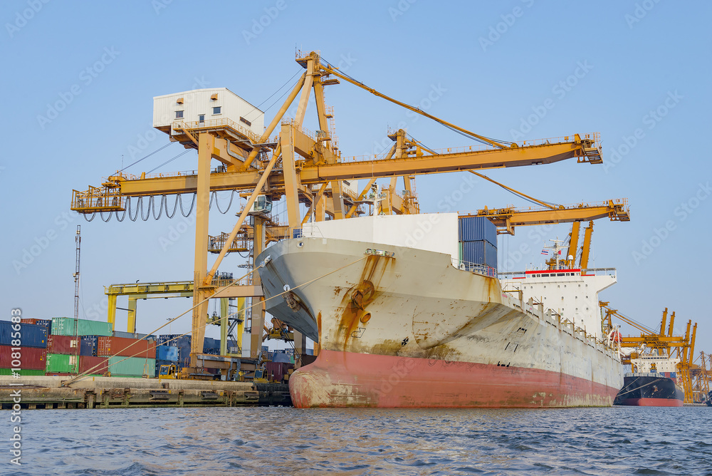 Container Cargo freight ship with working crane bridge in shipya Container Cargo freight ship with working crane bridge in shipya