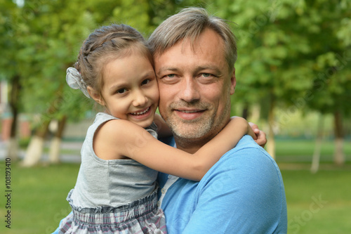 father with daughter in summer park