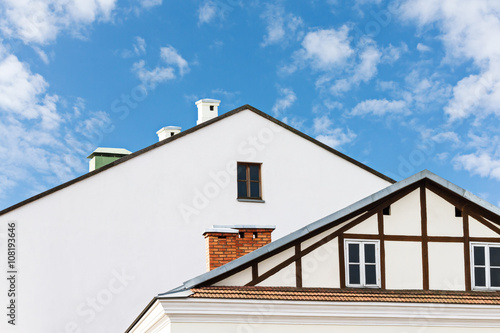 roofs of residential buildings against blue sky