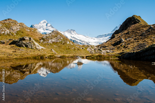 swiss mountains reflecting in a lake