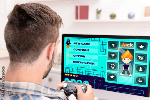 Young man playing computer ...