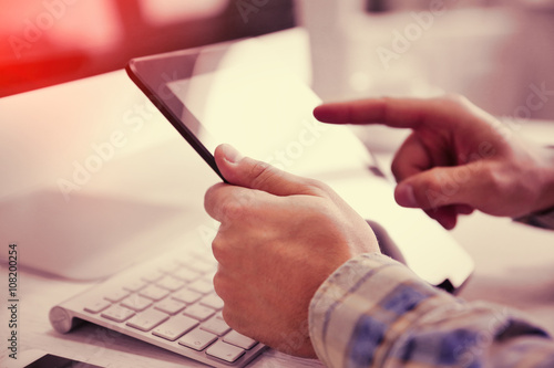 Young businessman using his tablet-pc, close up