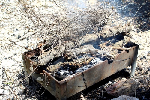 Firewood on burned charcoal. Preparing barbecue