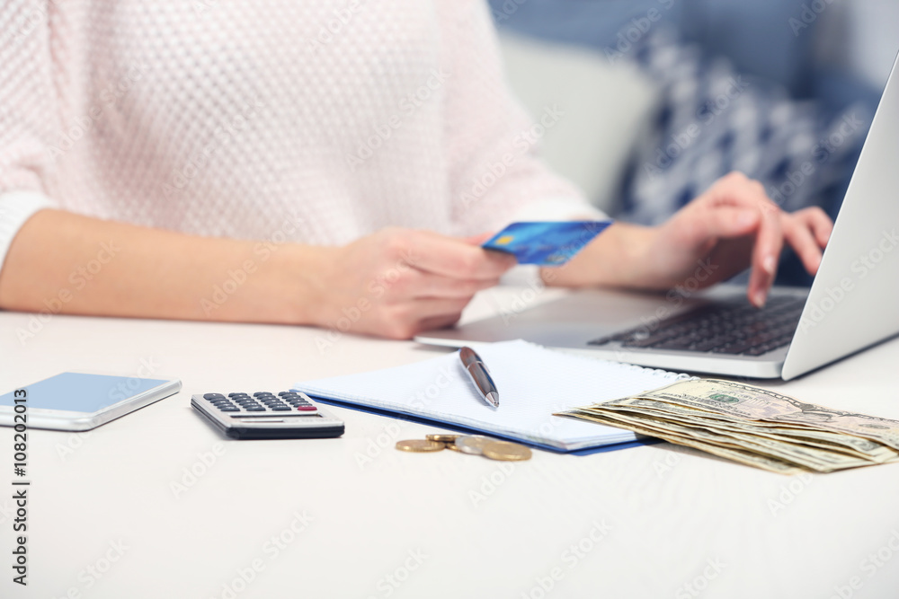 Woman counting money and making calculations Woman counting money and making calculations