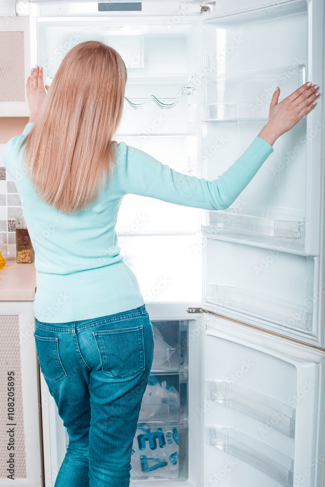 Young blonde at home near fridge Young blonde at home near fridge