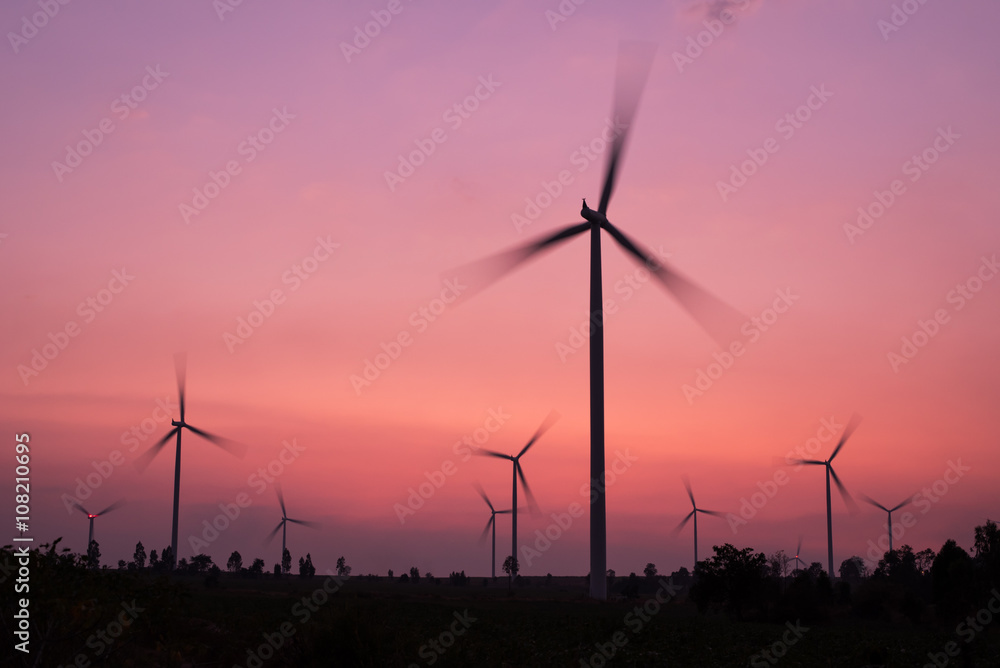 Obraz premium wind turbines spinning at twilight