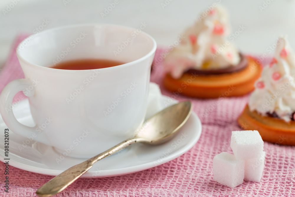 cup of tea with teaspoon and biscuit cakes cup of tea with teaspoon and biscuit cakes