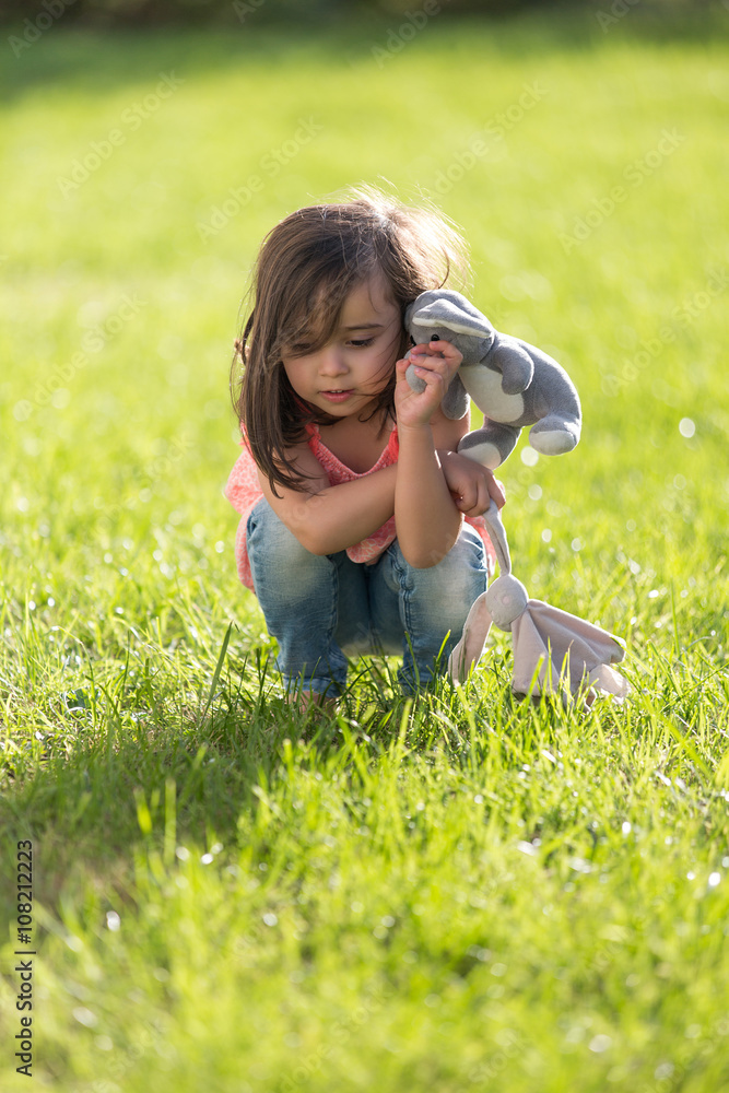 Fototapeta premium Sweet little girl outdoors playing