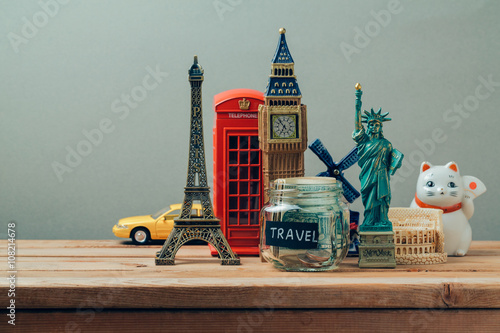 Travel and tourism concept with souvenirs from around the world. Planning summer vacation, money budget trip concept. Saving money for vacation.