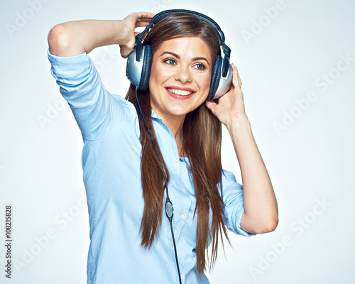 Woman listening music touching headphones.