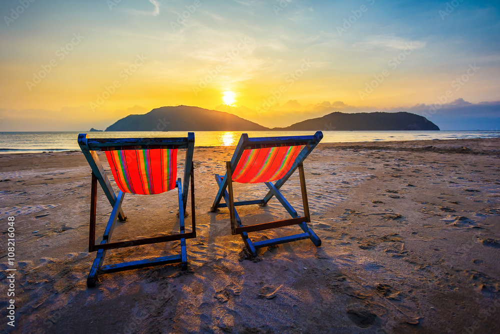 Two summer beach Chairs at sunset light