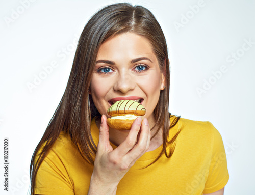 Close up face portrait of happy woman eatin macaron French cake