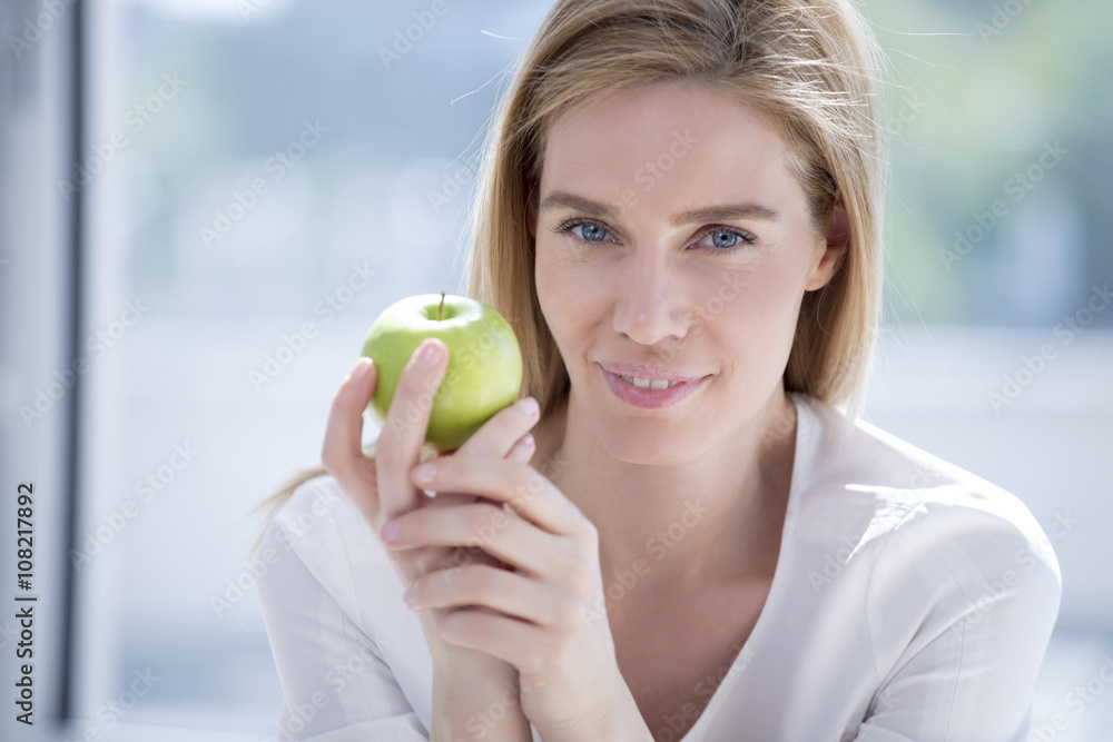 Blond woman, blue eyes and green apple; Nutritional value Blond woman, blue eyes and green apple; Nutritional value