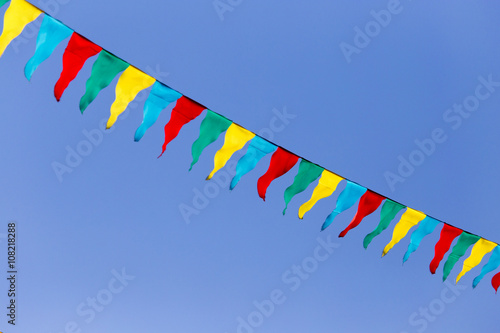 multicolored flags against the blue sky