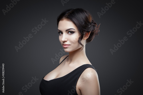 Portrait of beautiful female model on gray background