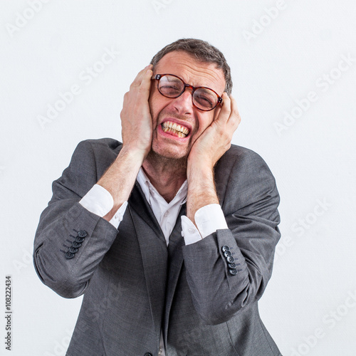 portrait of burnout for shouting middle aged businessman with headache