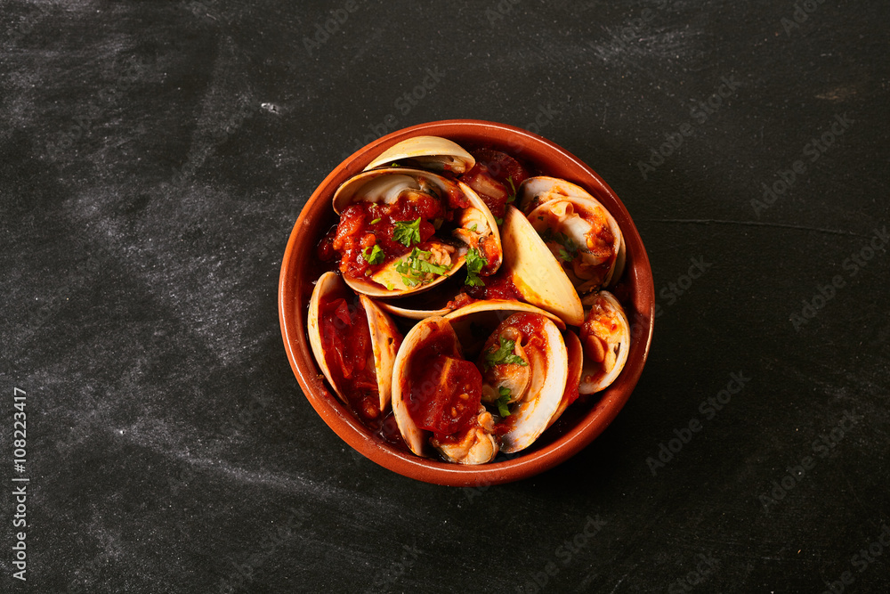 Bowl of Venus shell clams in a spicy sauce Bowl of Venus shell clams in a spicy sauce