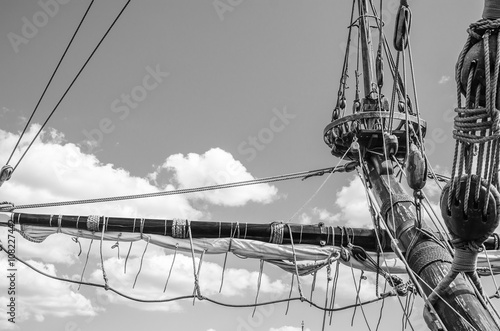 Mast with sails of an old sailing vessel, black and white photo
