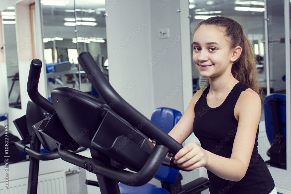 Girl is engaged in sports and gymnastics in the gym Girl is engaged in sports and gymnastics in the gym