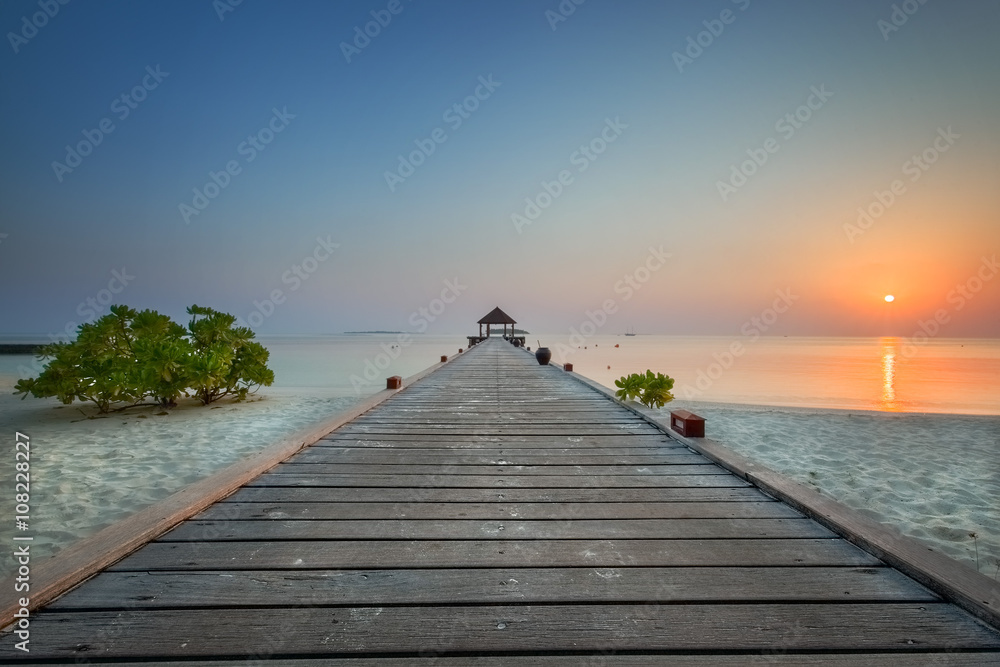 Jetty on the island of Komandoo in the Maldives at sunrise.