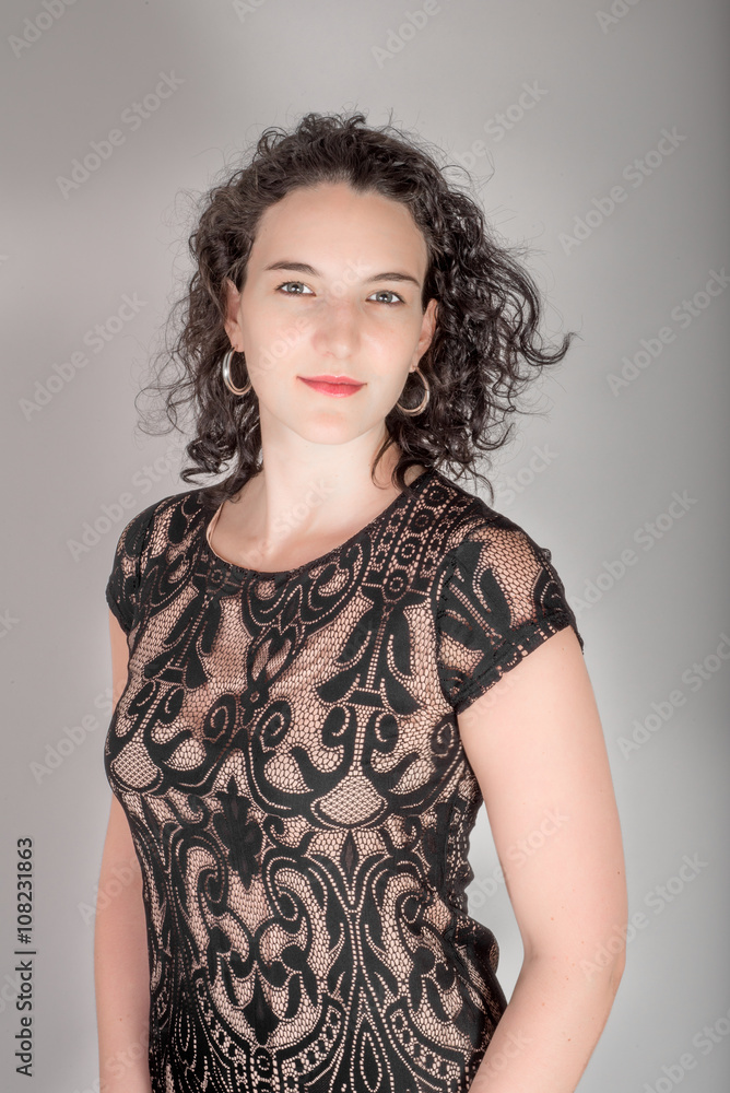 Portrait of a young woman with black hair and black blue dress.. Portrait of a young woman with black hair and black blue dress..