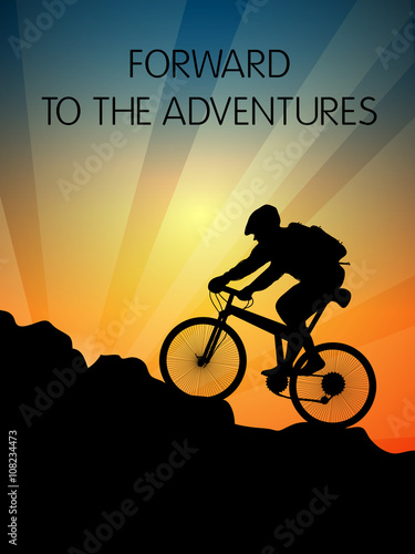 Bicyclist and sunset in the mountains