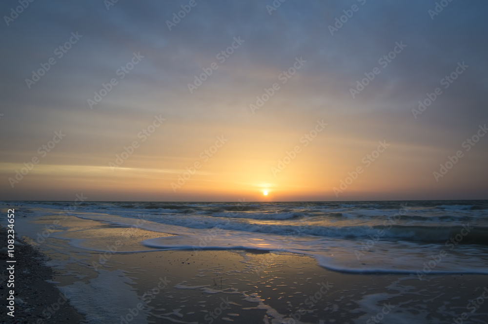 Beautiful sunrise at sea, waves, beach