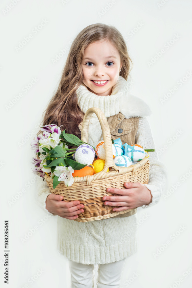 Smiling little girl with basket full of colorful easter eggs Smiling little girl with basket full of colorful easter eggs