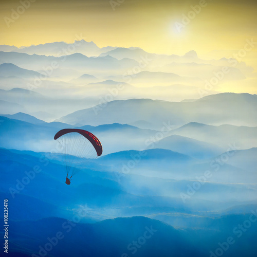 Paraglide silhouette in a light of sunrise