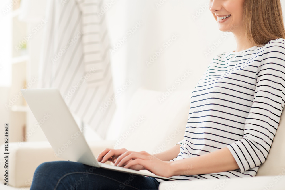 Positive girl working on the laptop Positive girl working on the laptop