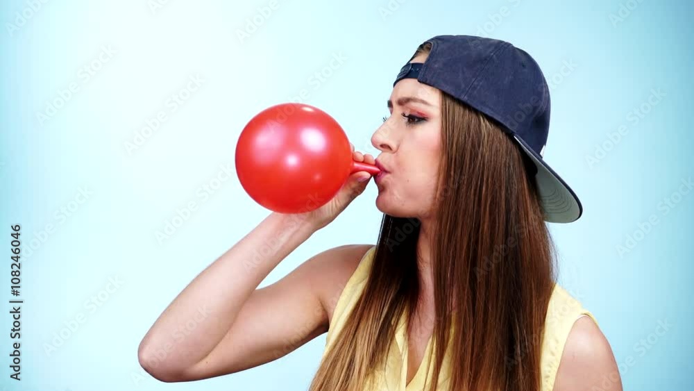 Woman casual style blowing up a red balloon 4K Woman casual style blowing up a red balloon 4K