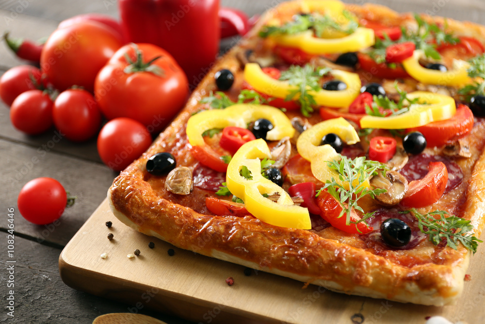 Rectangle delicious pizza and vegetables on the table Rectangle delicious pizza and vegetables on the table