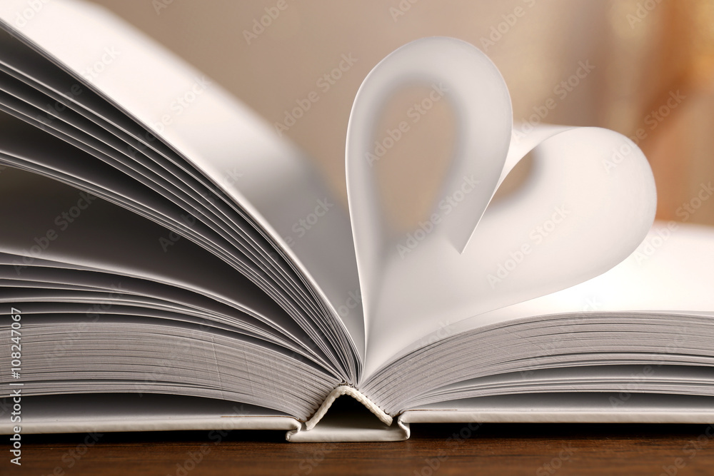 Heart from book pages on blurred background Heart from book pages on blurred background