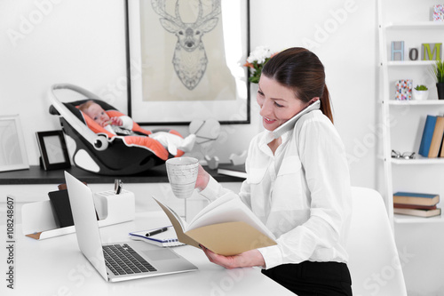 Businesswoman with baby boy...