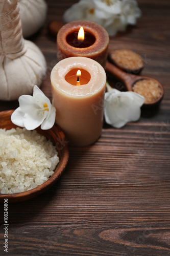 Spa set with sea salt  exotic flowers and candles on wooden background
