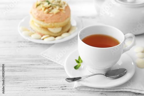 Cup of tea with nut cake on wooden background