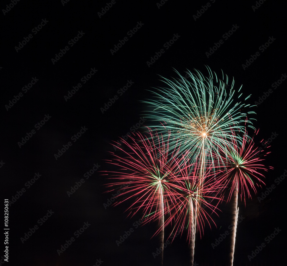 Fireworks light the night sky and beautiful. Space on a black background.