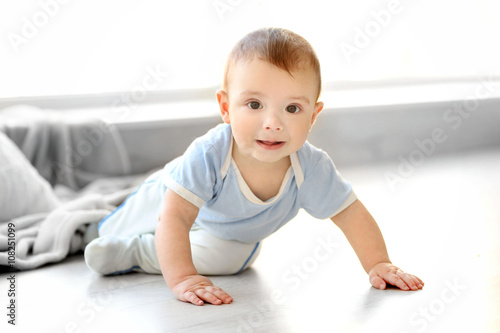 Little baby boy crawling on...