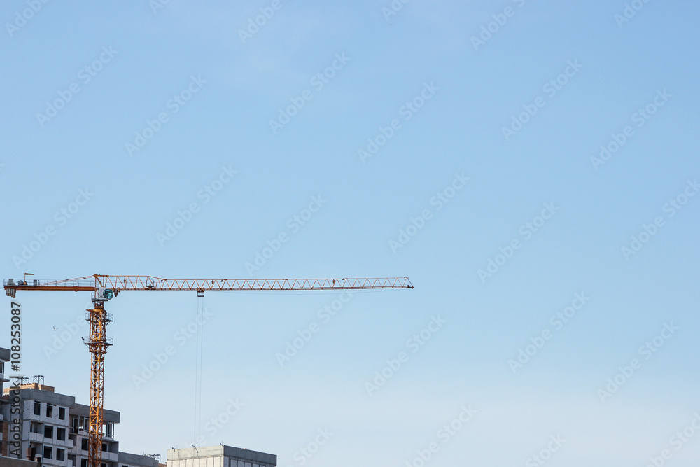 building and construction crane with blue sky background